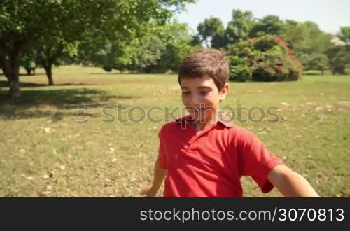 Sport, children, young people and recreation with white hispanic child playing soccer, boy and football game in park, training.