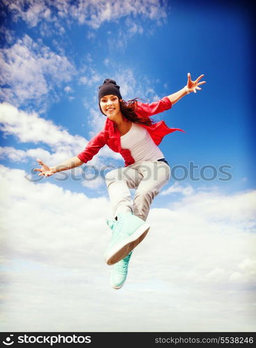 sport, dancing and urban culture concept - beautiful dancing girl jumping