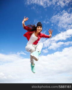 sport, dancing and urban culture concept - beautiful dancing girl jumping
