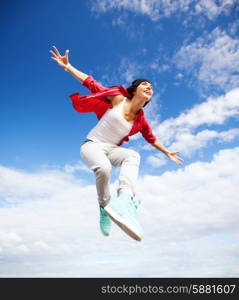 sport, dancing and urban culture concept - beautiful dancing girl jumping