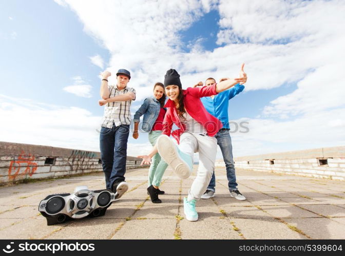 sport, dancing and urban culture concept - group of teenagers dancing