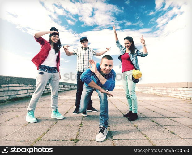 sport, dancing and urban culture concept - group of teenagers dancing