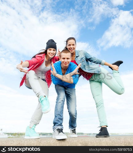 sport, dancing and urban culture concept - group of teenagers dancing