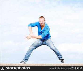 sport, dancing and urban culture concept - handsome boy making dance move