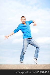 sport, dancing and urban culture concept - handsome boy making dance move