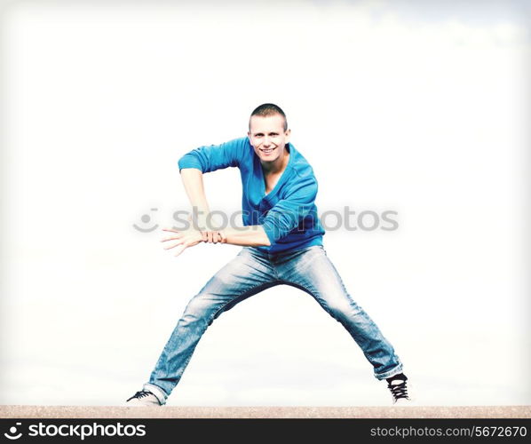 sport, dancing and urban culture concept - handsome boy making dance move