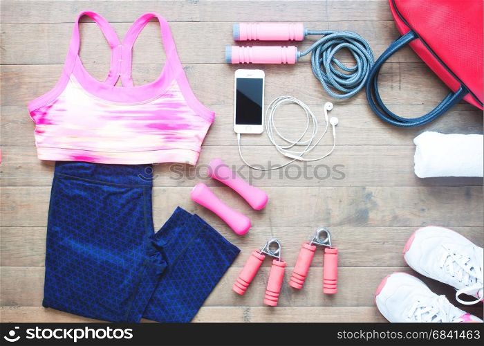 Sport equipments. Sport bra. Smartphone and sport shoes on wood floor, Healthy lifestyle concept
