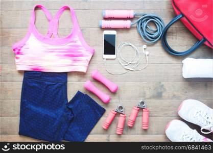 Sport equipments. Sport bra. Smartphone and sport shoes on wood floor, Healthy lifestyle concept