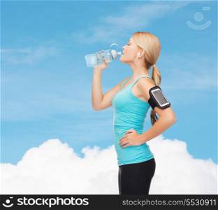 sport, excercise, technology, internet and healthcare - sporty woman listening to music from smartphone with water bottle