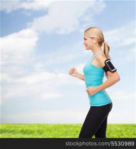sport, excercise, technology, internet and healthcare - sporty woman running and listening to music from smartphone