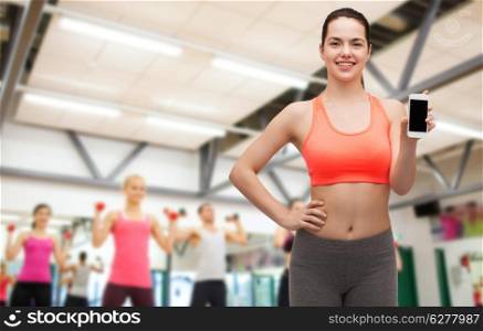 sport, excercise, technology, internet and healthcare - sporty woman with blank smartphone screen
