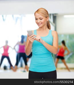 sport, excercise, technology, internet and healthcare - sporty woman with smartphone