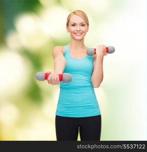 sport, excercising and healthcare concept - young sporty woman with light dumbbells