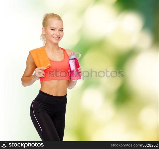 sport, exercise and healthcare concept - sporty woman with orange towel and water bottle