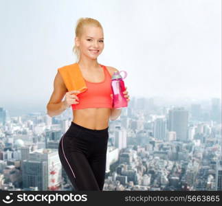 sport, exercise and healthcare concept - sporty woman with orange towel and water bottle