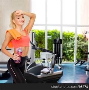 sport, exercise and healthcare - smiling sporty woman with orange towel and water bottle