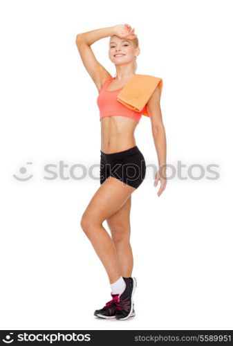 sport, exercise and healthcare - smiling sporty woman with towel wiping of sweat