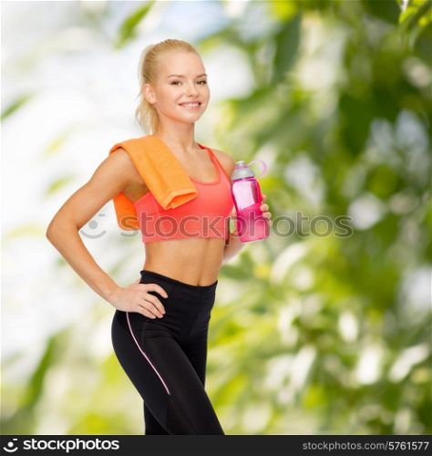 sport, exercise and healthcare - sporty woman with orange towel and water bottle