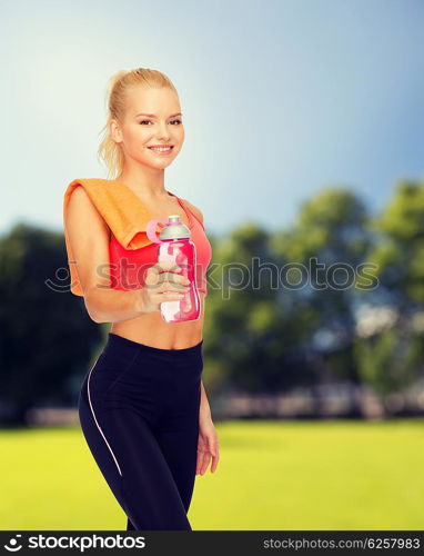 sport, exercise and healthcare - sporty woman with orange towel and water bottle