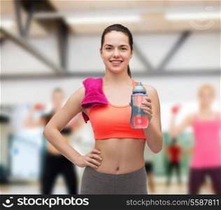 sport, exercise and healthcare - sporty woman with pink towel and water bottle
