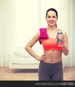 sport, exercise and healthcare - sporty woman with pink towel and water bottle