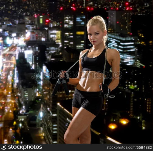 sport, exercise and healthcare - sporty woman with skipping rope