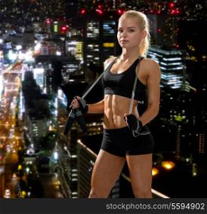 sport, exercise and healthcare - sporty woman with skipping rope