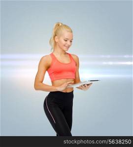 sport, exercise, technology, internet and healthcare concept - smiling sporty woman with tablet pc computer