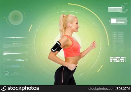 sport, exercise, technology, internet and healthcare - smiling sporty woman running with smartphone and earphones and listening to music over green background. sporty woman running with smartphone and earphones