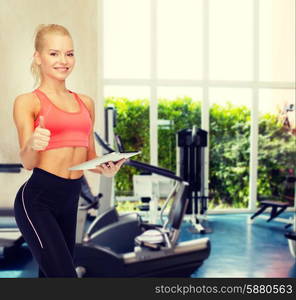 sport, exercise, technology, internet and healthcare - smiling sporty woman with tablet pc computer showing thumbs up