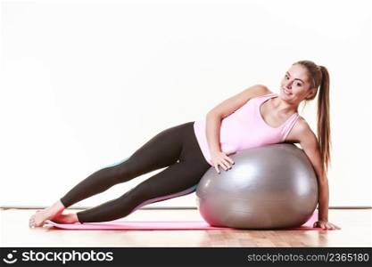 Sport exercises workout health concept. Tired girl resting. Exhausted lady catching a breath after exercising with fitness ball.. Girl exercising with fit ball