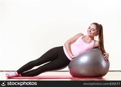 Sport exercises workout health concept. Tired girl resting. Exhausted lady catching a breath after exercising with fitness ball.. Girl exercising with fit ball