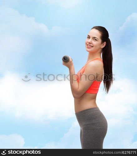 sport, exercising and healthcare concept - young sporty woman with light dumbbells