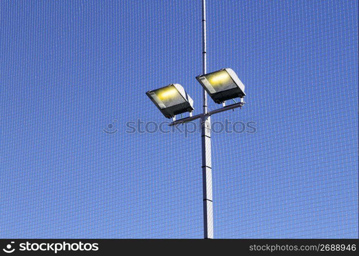 sport field lighting equipment spots light blue sky