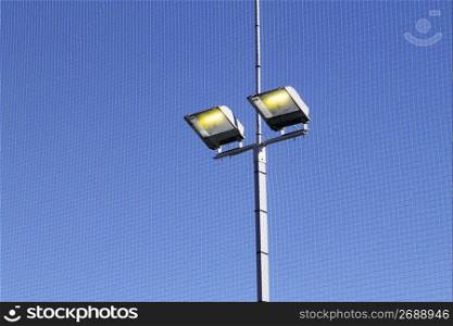 sport field lighting equipment spots light blue sky
