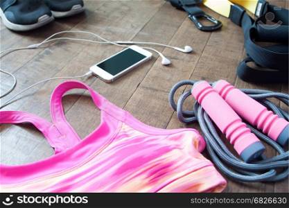 Sport fitness accessories in pink and black color on wood floor, Workout concept