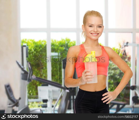 sport, fitness and diet concept - smiling sporty woman with protein shake bottle