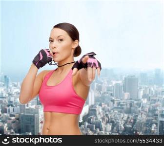 sport, fitness and healthcare concept - beautiful asian personal trainer with whistle