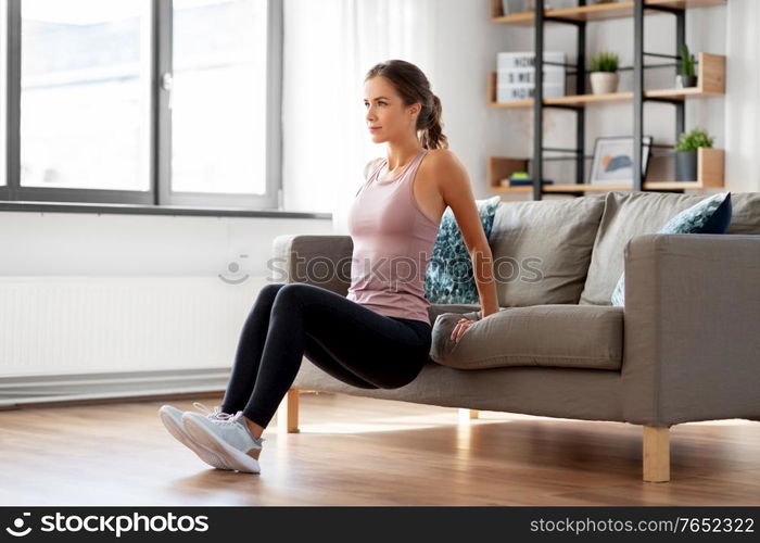 sport, fitness and healthy lifestyle concept - young woman exercising at home. young woman exercising at home