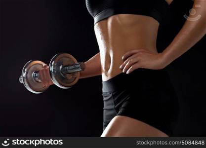 sport, fitness and people concept - close up of young sporty woman exercising with dumbbell. close up of sporty woman exercising with dumbbell. close up of sporty woman exercising with dumbbell