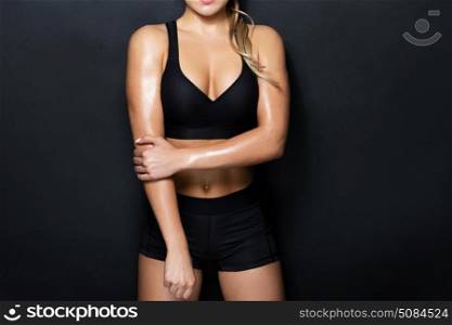 sport, fitness and people concept - close up of young woman in black sportswear posing in gym. close up of woman in black sportswear posing. close up of woman in black sportswear posing