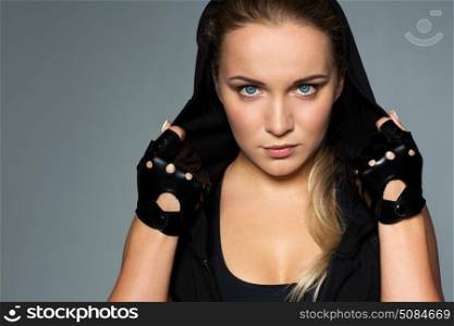 sport, fitness and people concept - close up of young woman in black sportswear posing in gym. close up of woman in black sportswear. close up of woman in black sportswear