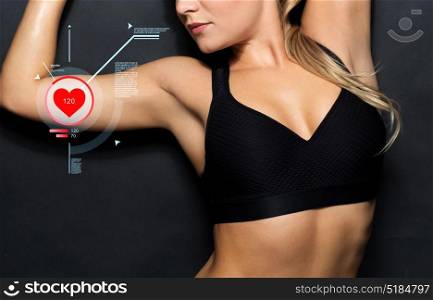 sport, fitness and people concept - close up of young woman in black sportswear posing with pulse. close up of woman in black sportswear with pulse