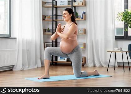 sport, fitness and people concept - happy pregnant woman exercising at home. happy pregnant woman doing sports at home