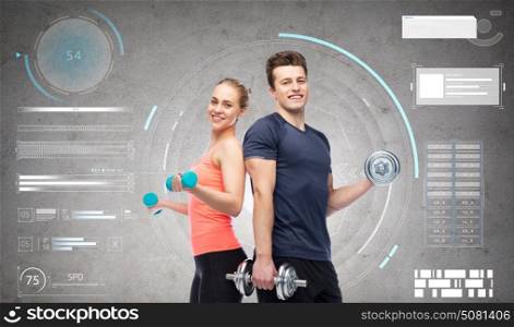 sport, fitness and people concept - happy sportive man and woman with dumbbells flexing muscles over gray background. sportive man and woman with dumbbells