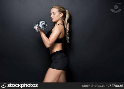 sport, fitness and people concept - young sporty woman exercising with dumbbell. young sporty woman exercising with dumbbell