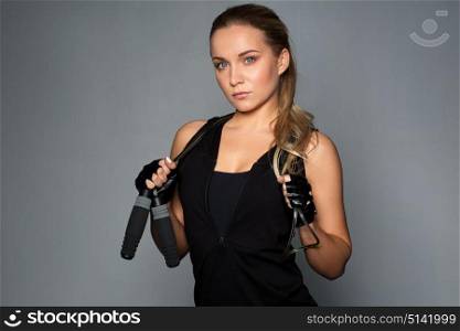 sport, fitness and people concept - young sporty woman with jumping rope. young sporty woman with jumping rope