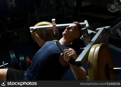 sport, fitness, bodybuilding and people concept - man doing chest press on exercise machine in gym. man doing chest press on exercise machine in gym