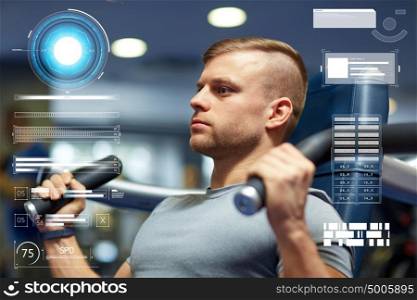 sport, fitness, bodybuilding, exercising and people concept - man flexing muscles on gym machine over virtual charts. man exercising and flexing muscles on gym machine