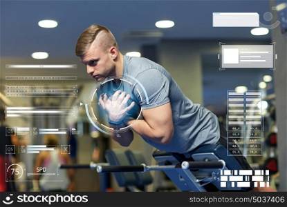 sport, fitness, bodybuilding, exercising and people concept - young man flexing back and abdominal muscles on bench in gym over virtual charts. young man flexing back muscles on bench in gym